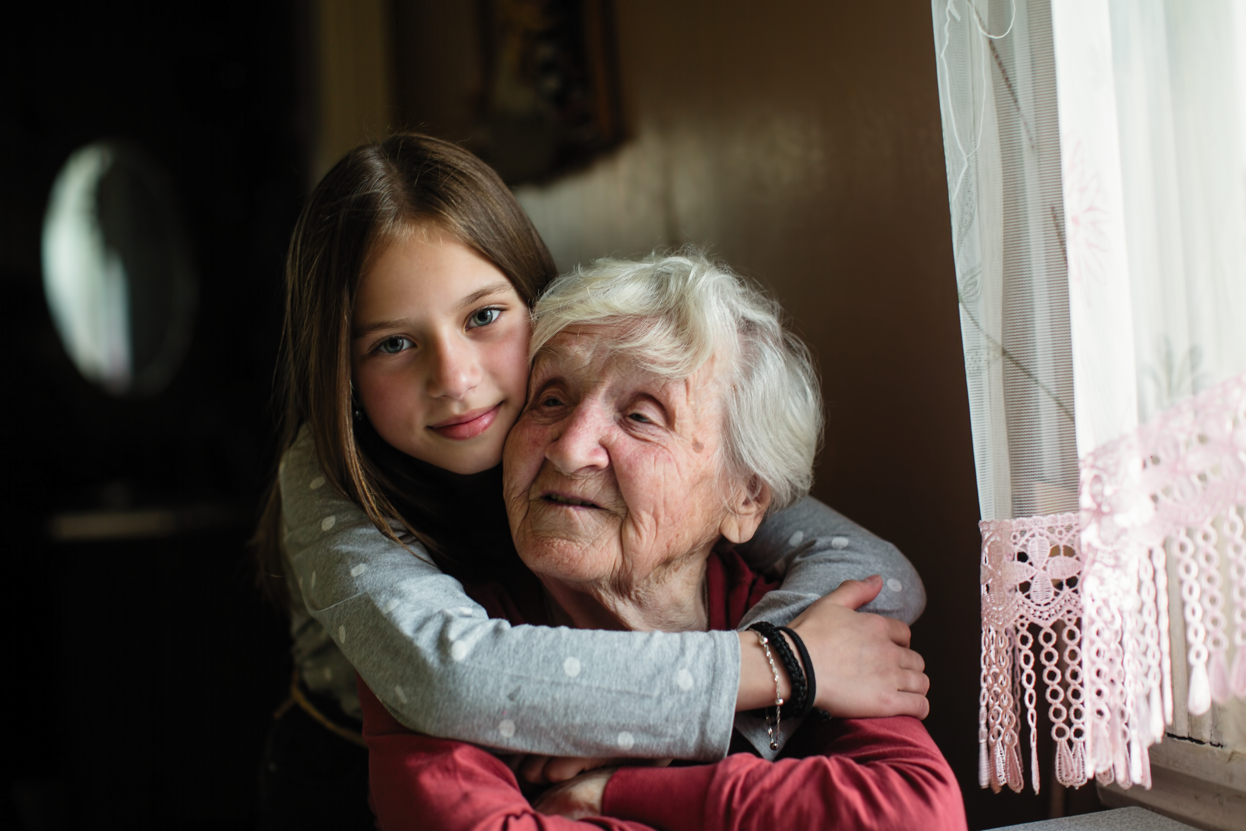 Granddaughter hugs grandmother