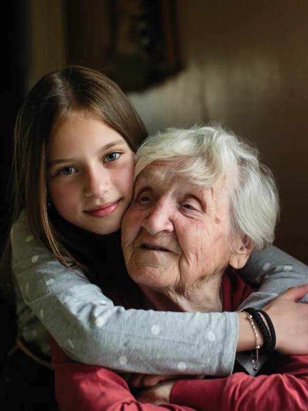 Granddaughter hugs grandmother